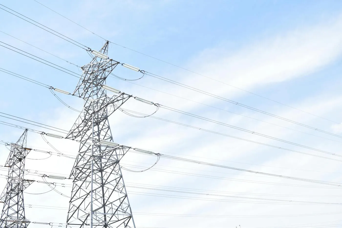 Electricity transmission pylons against a clear sky